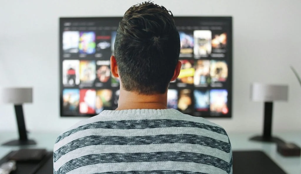 a man watching Netflix on TV